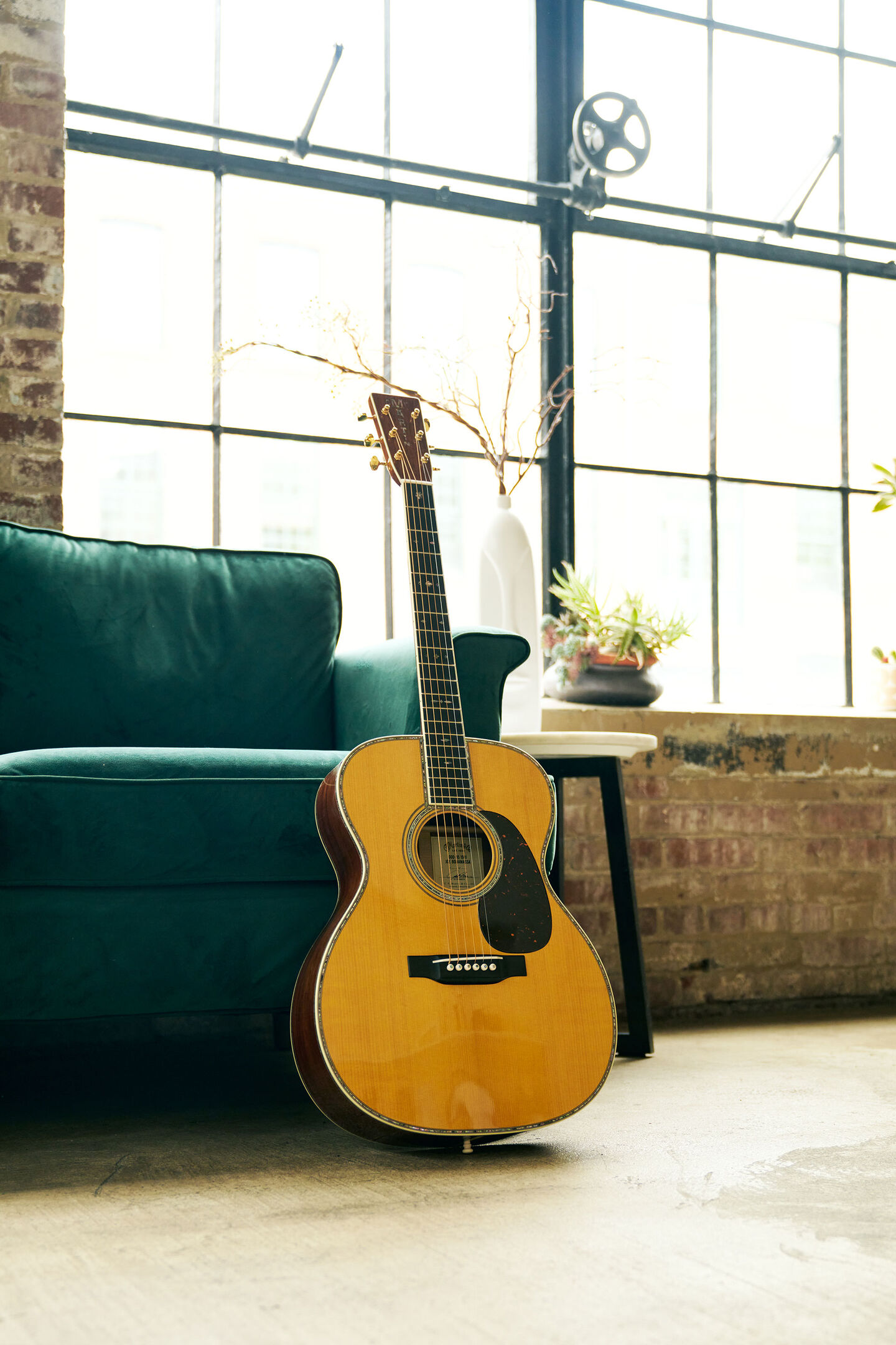Acoustic guitar leaning against a couch