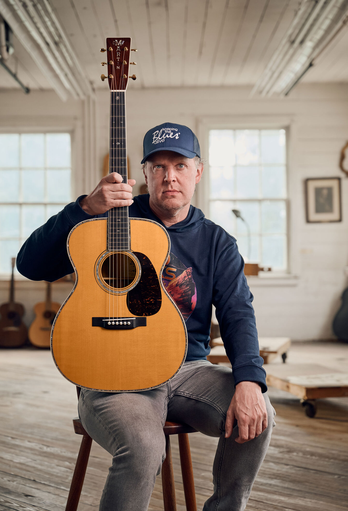 Joe Bonamassa sitting with his guitar