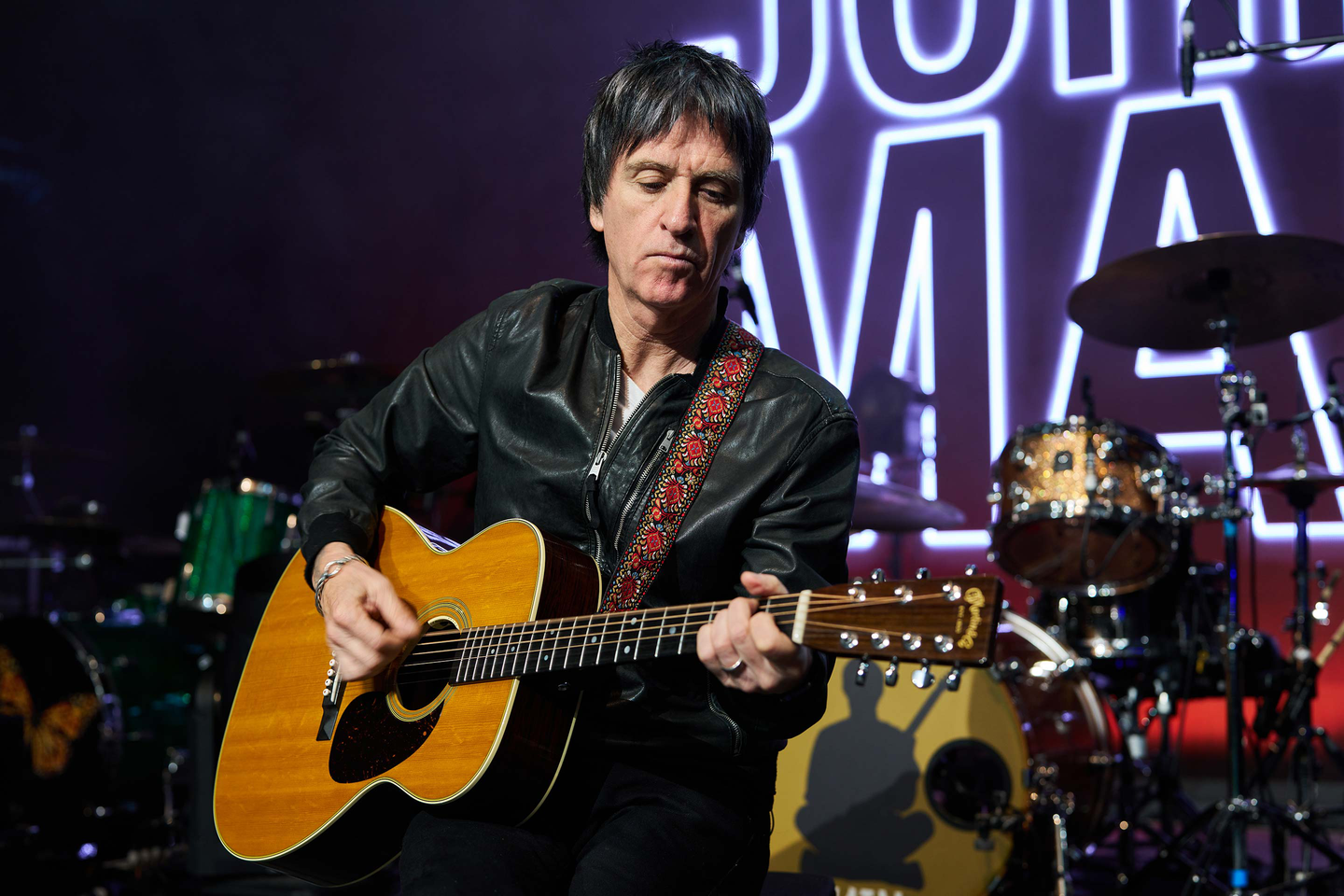 Johnny Marr playing his guitar on stage