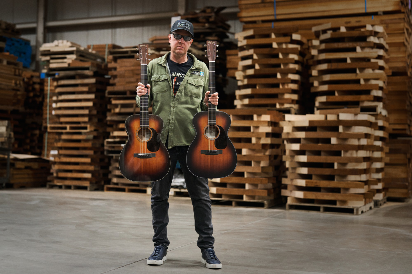 Joe Bonamassa standing with his two guitars