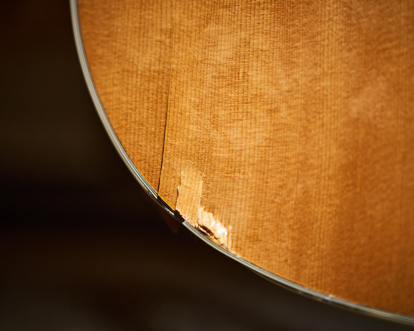 Dent and chip on the front of an acoustic guitar