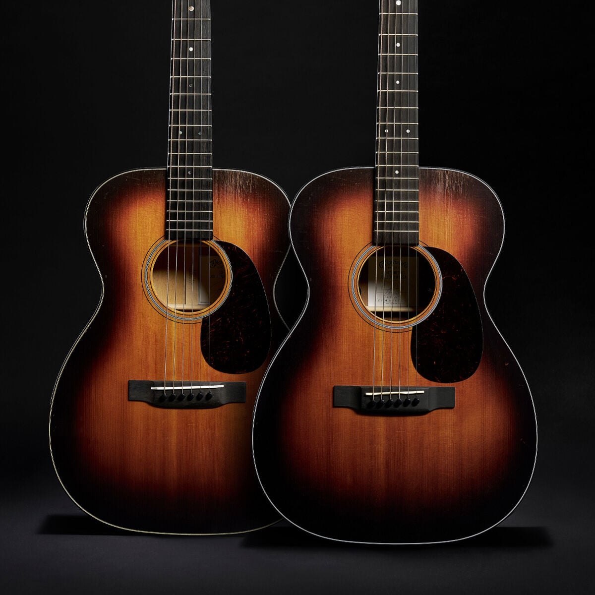 Two guitars on a black background