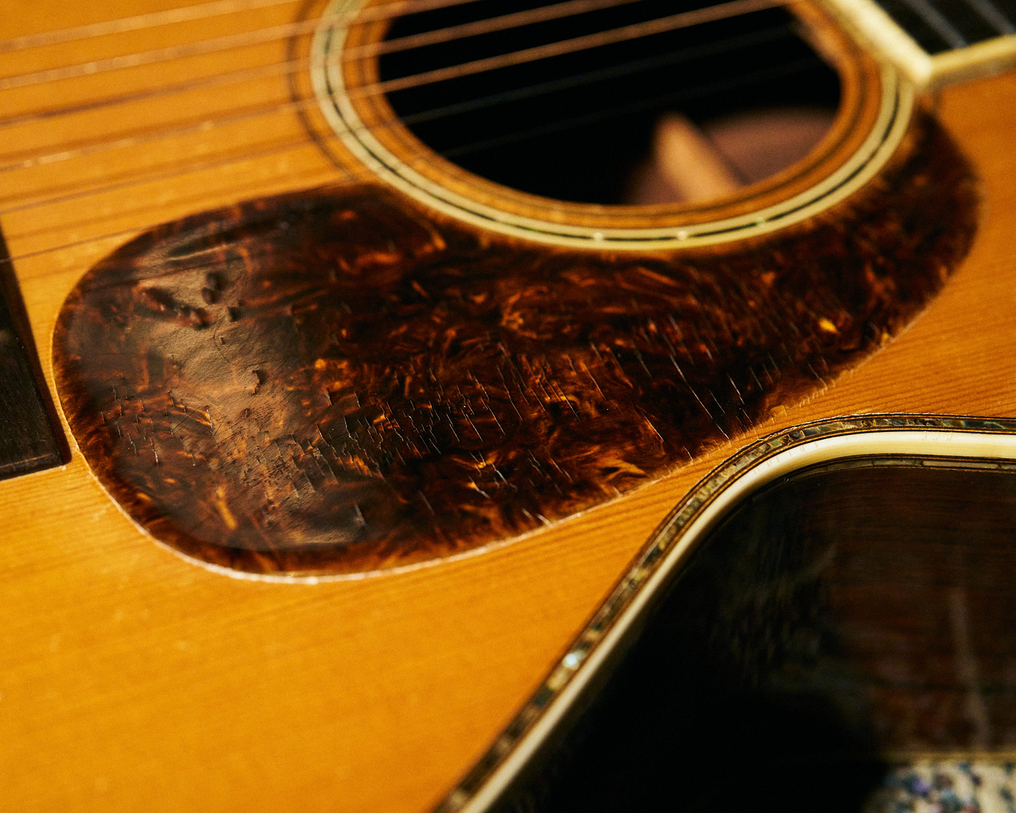 The pickguard on John's guitar