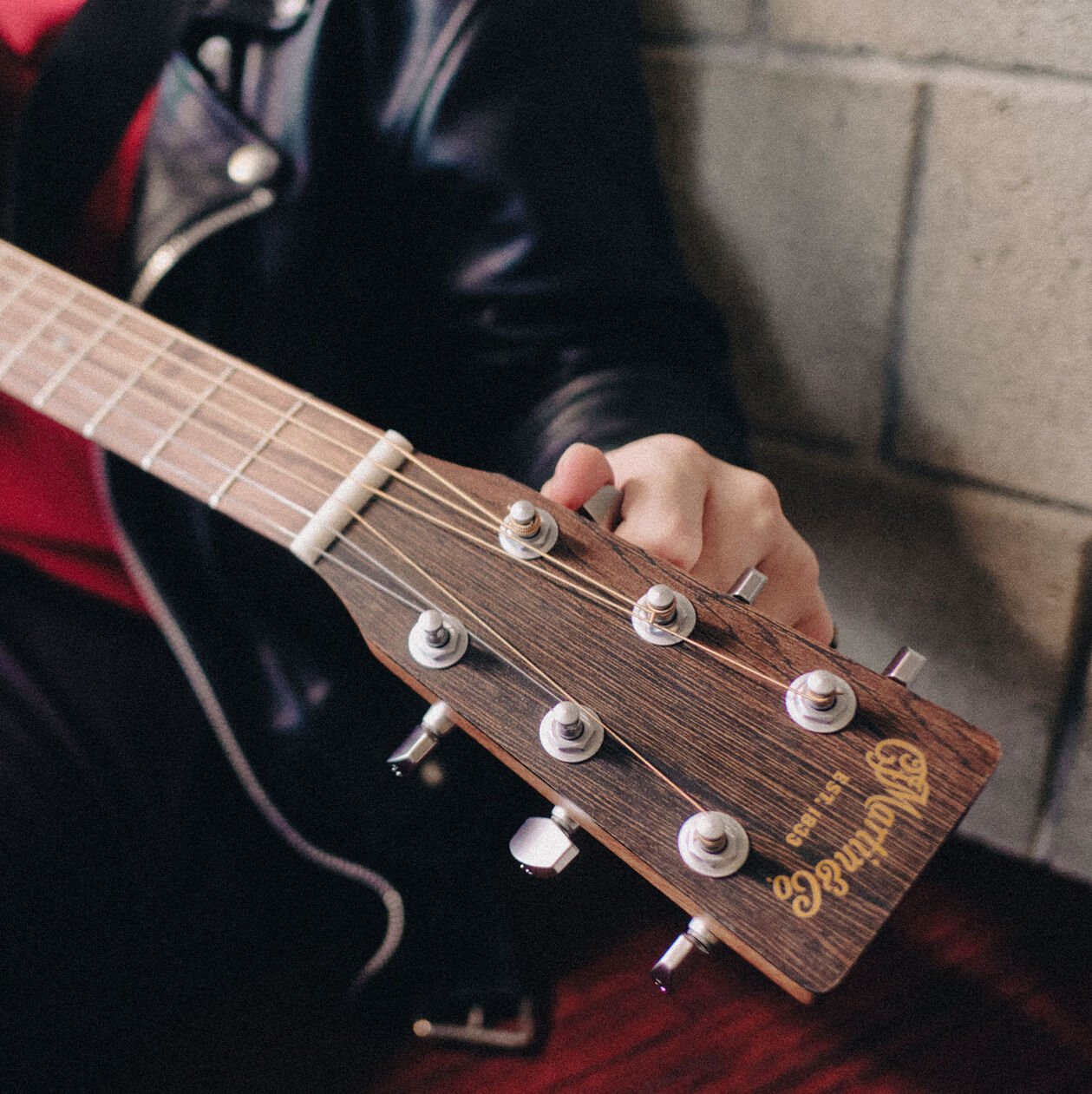 A person tuning a guitar A person tuning a guitar