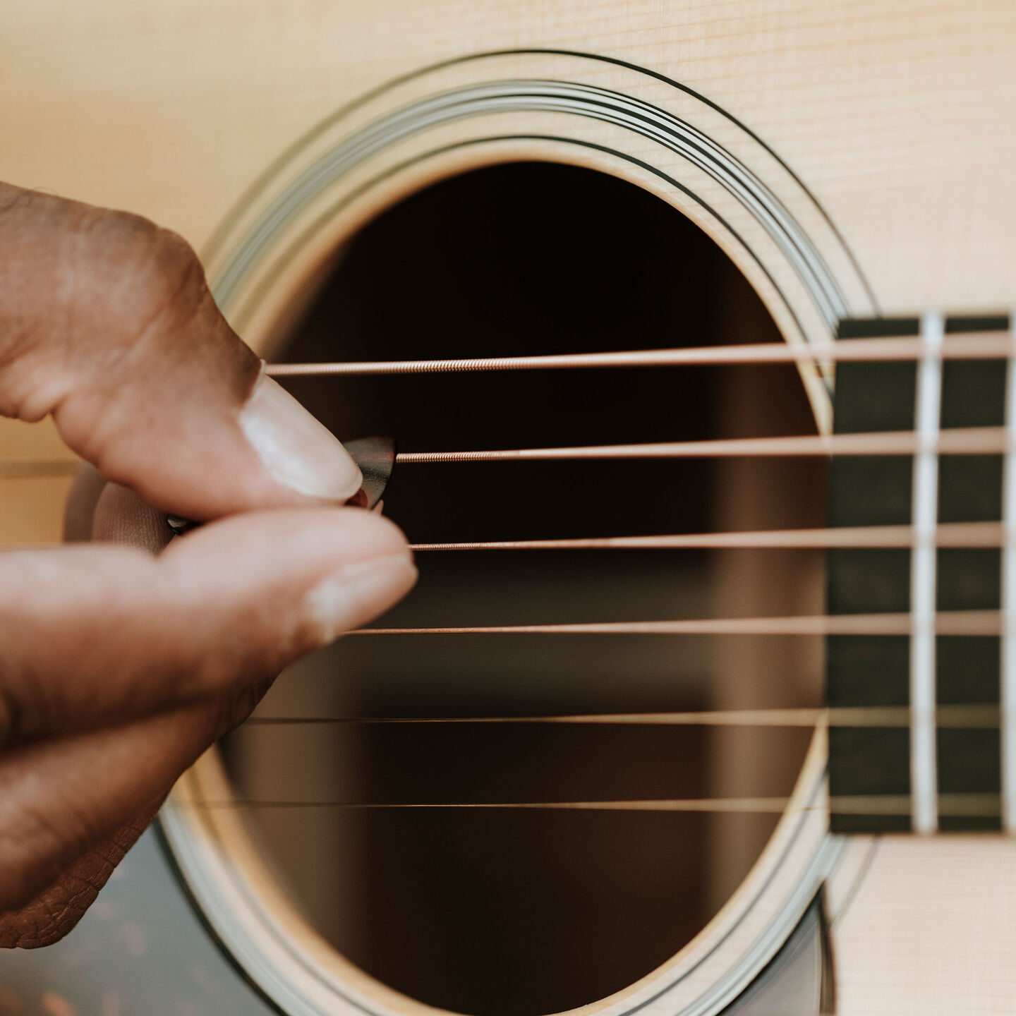 Close up of strumming a guitar