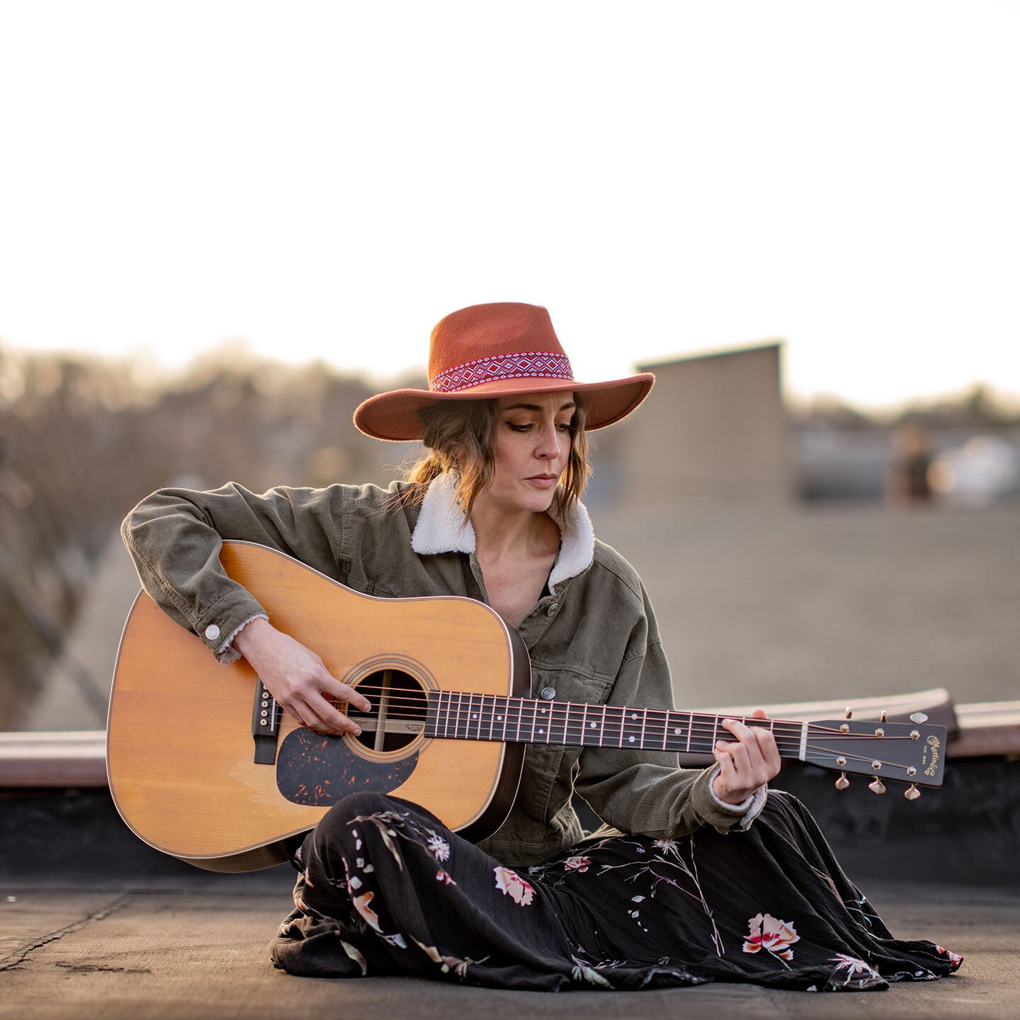 Woman playing guitar outside