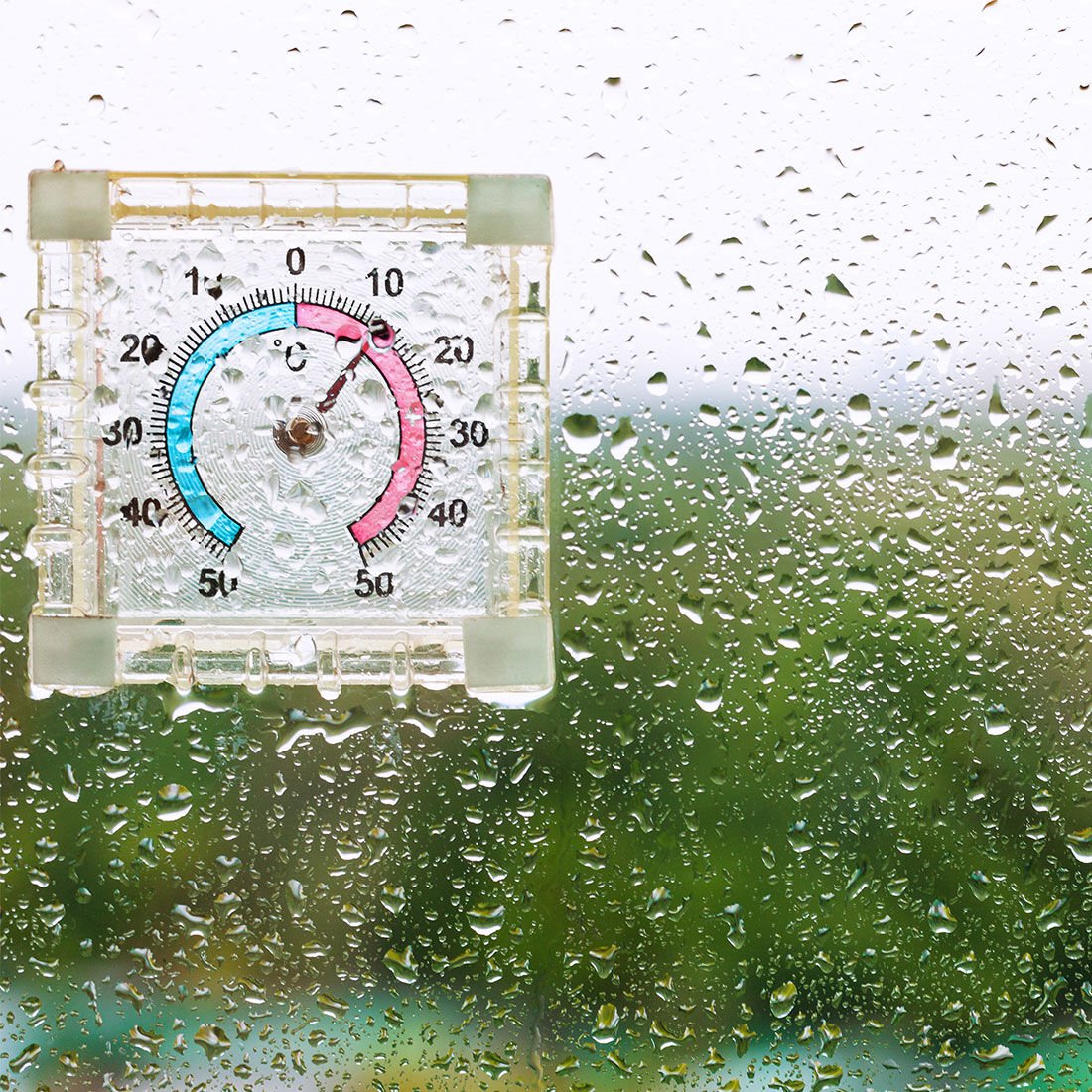 Moisture on a window looking at a humidity meter