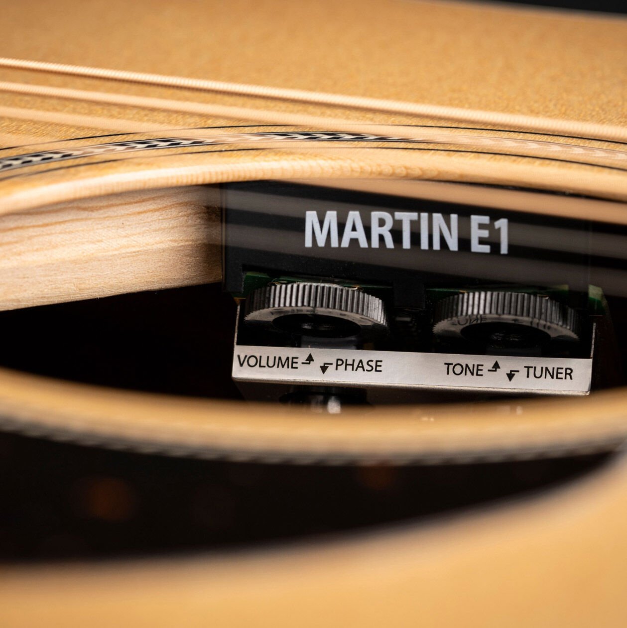 A closeup of Martin E1 electronics inside the sound hole of an acoustic guitar