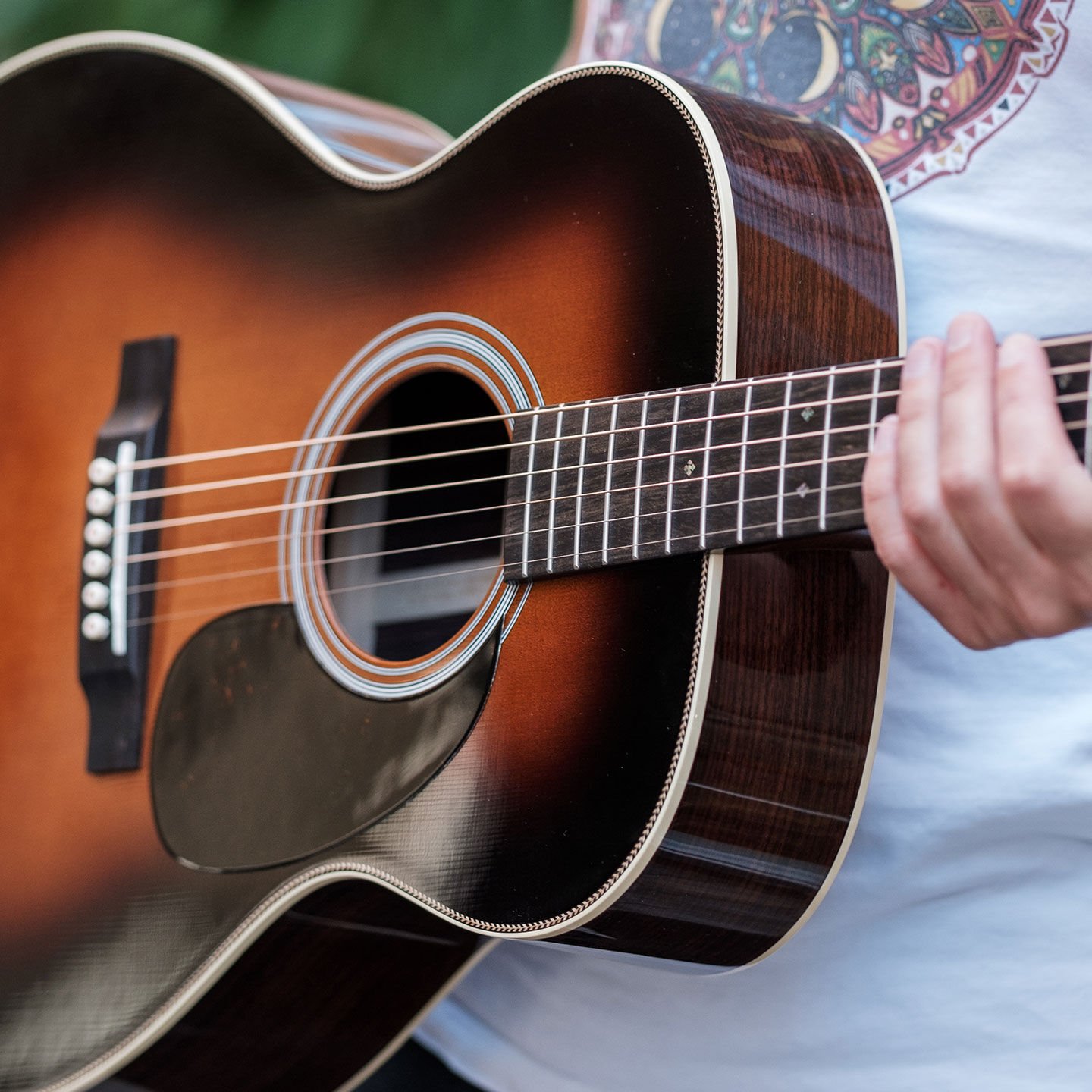 Person holding guitar Person holding guitar
