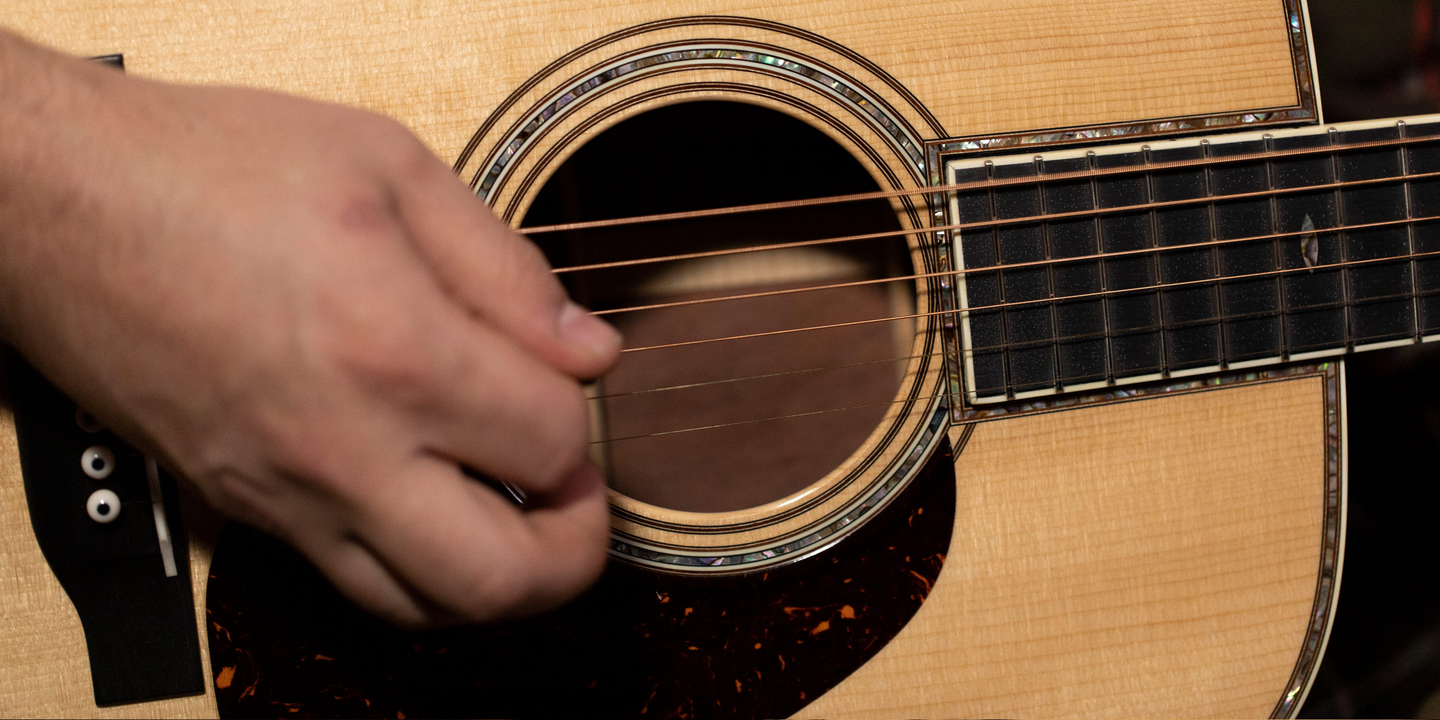 Person playing an acoustic guitar
