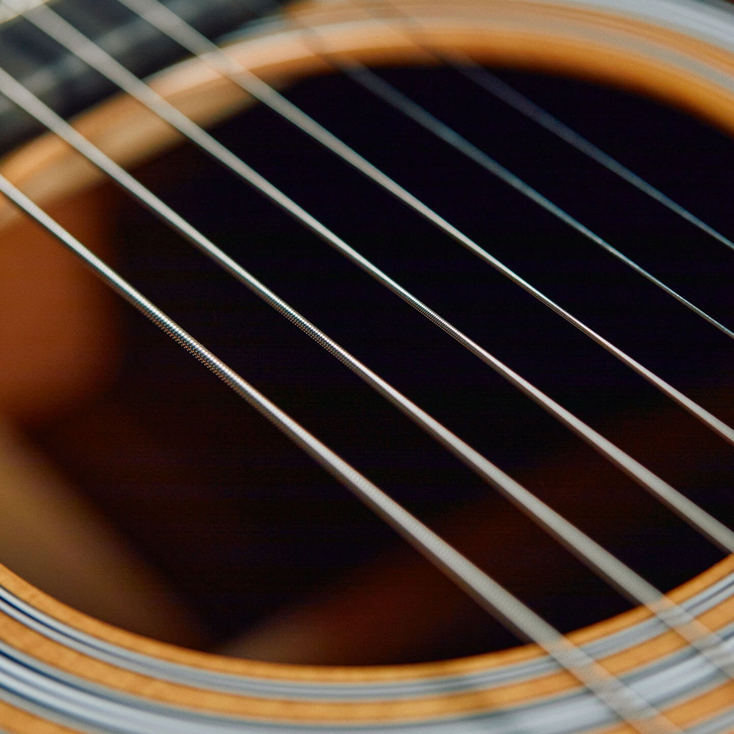 Strings over soundhole of guitar