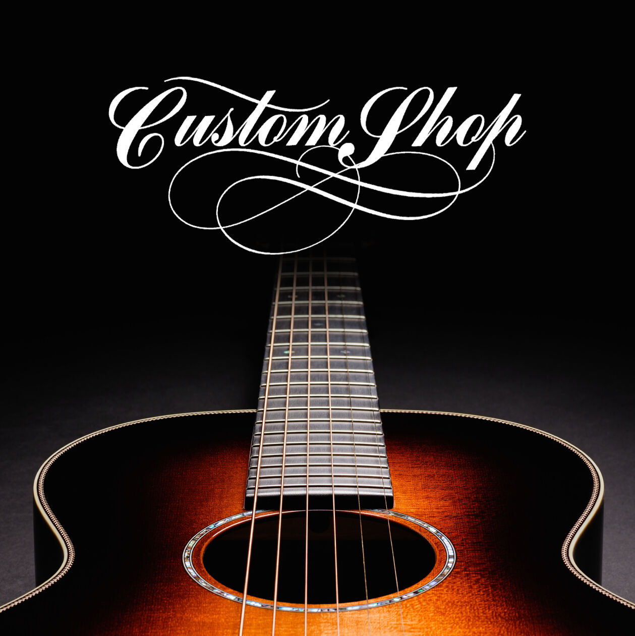 photo of an acoustic guitar on a black background, with stylized type that says custom shop