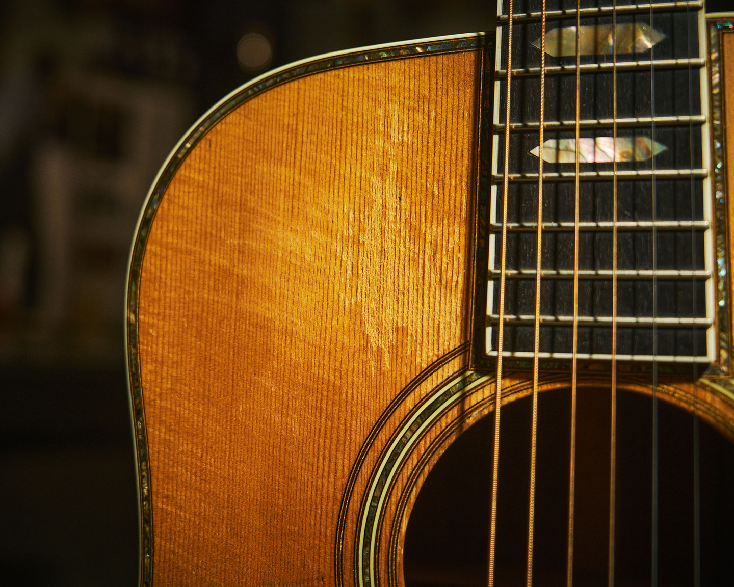 Closeup of the shoulder and bottom of the fretboard on a pre-war D-45 acoustic guitar