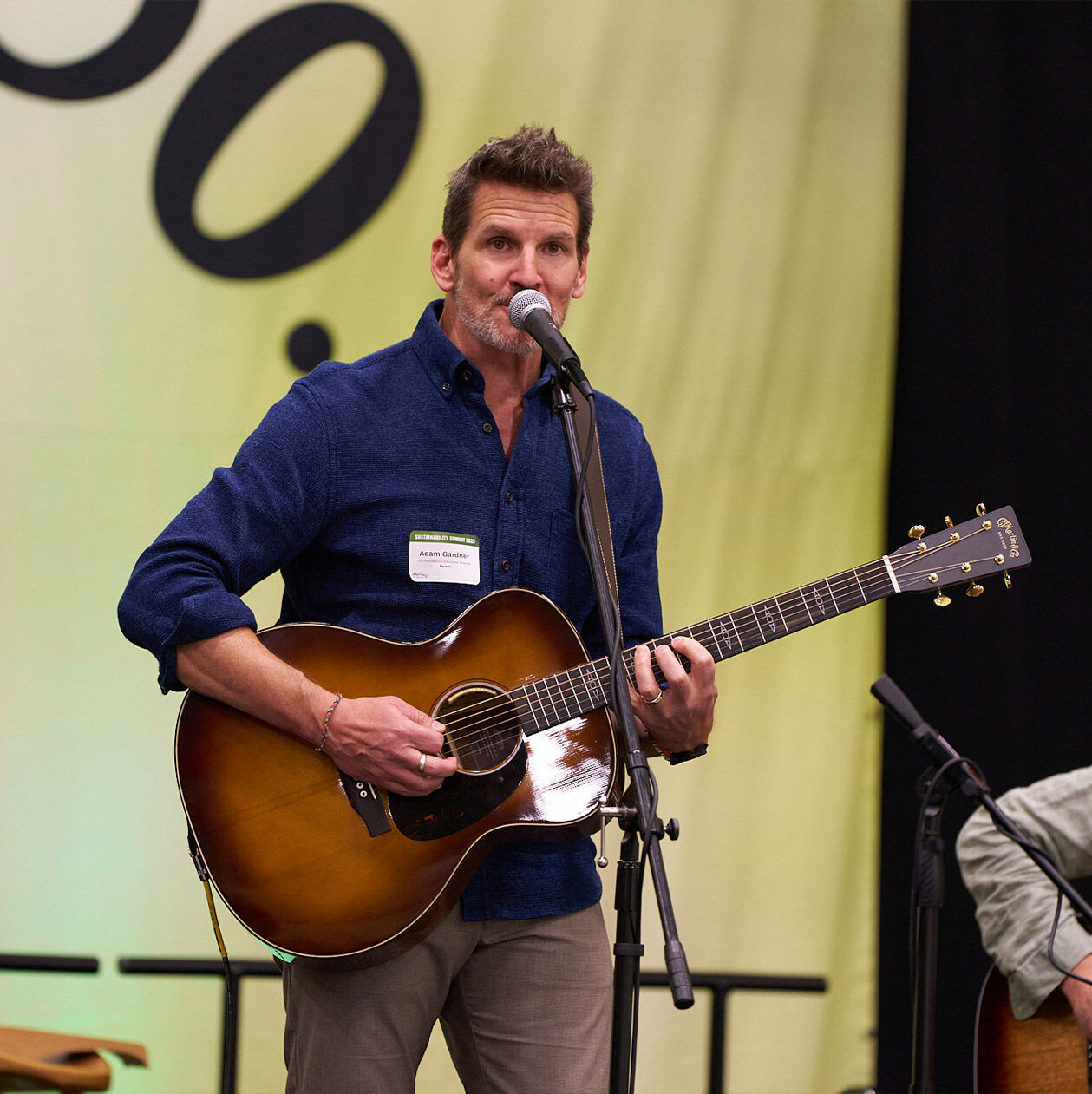 Person playing the guitar at the Martin Sustainability Summit