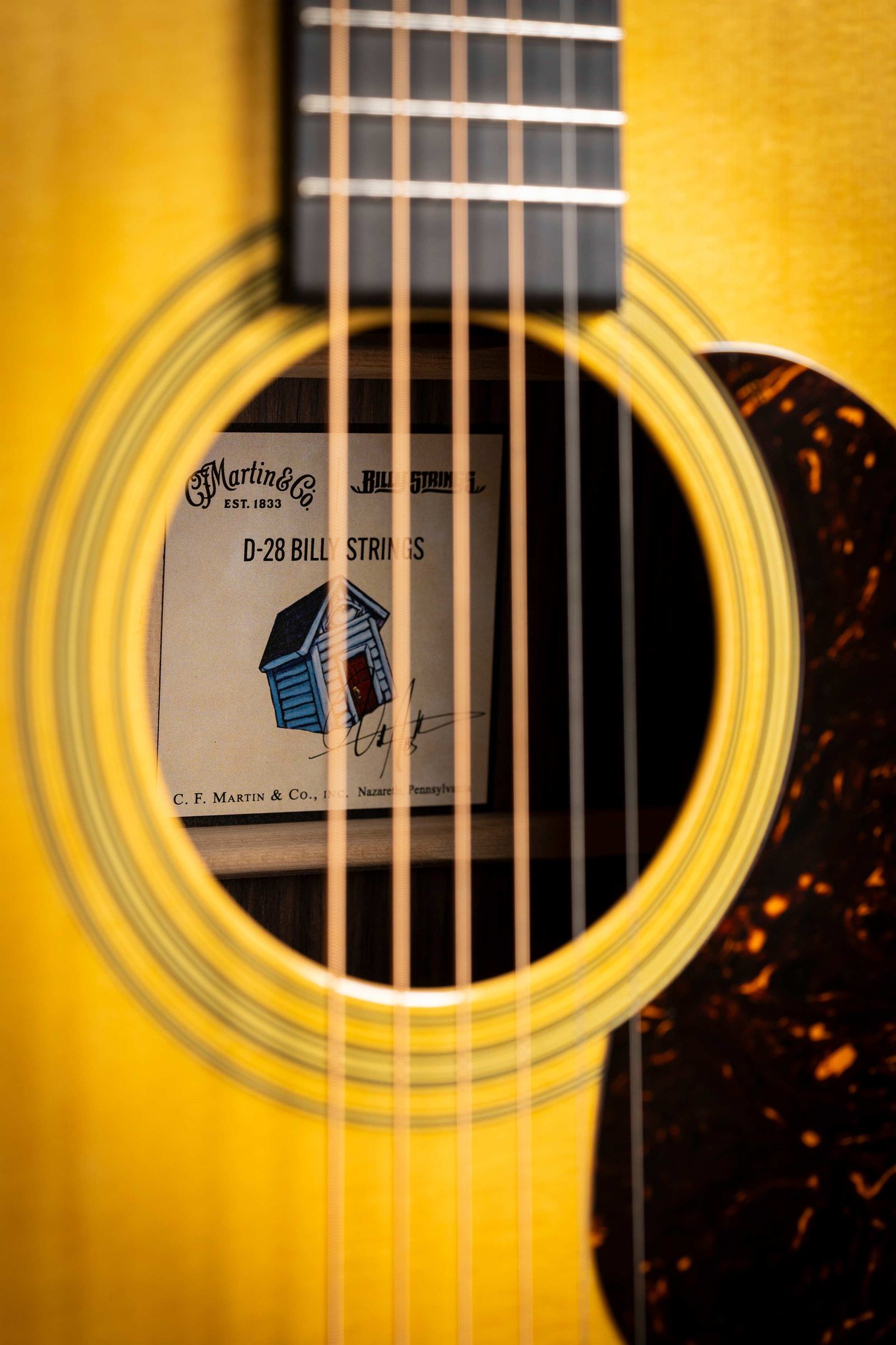 Photo of the D-28 Billy Strings acoustic guitar on its side