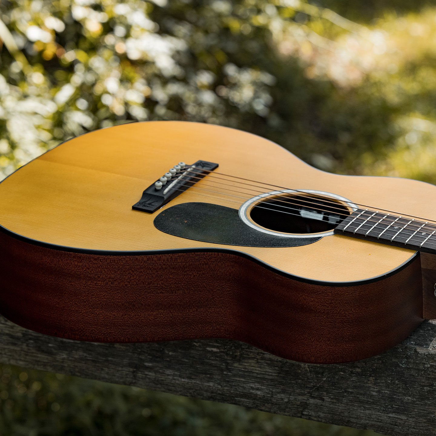 Close up of a guitar body laying outside