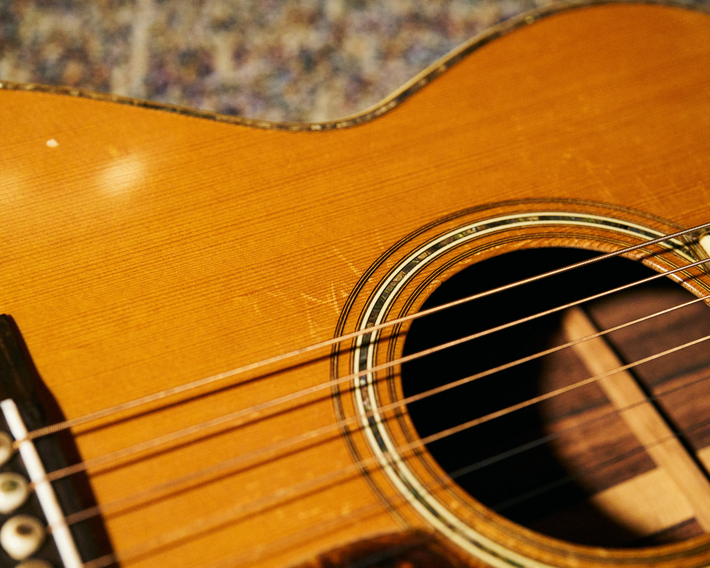 Closeup of the sound hole and top of John's guitar