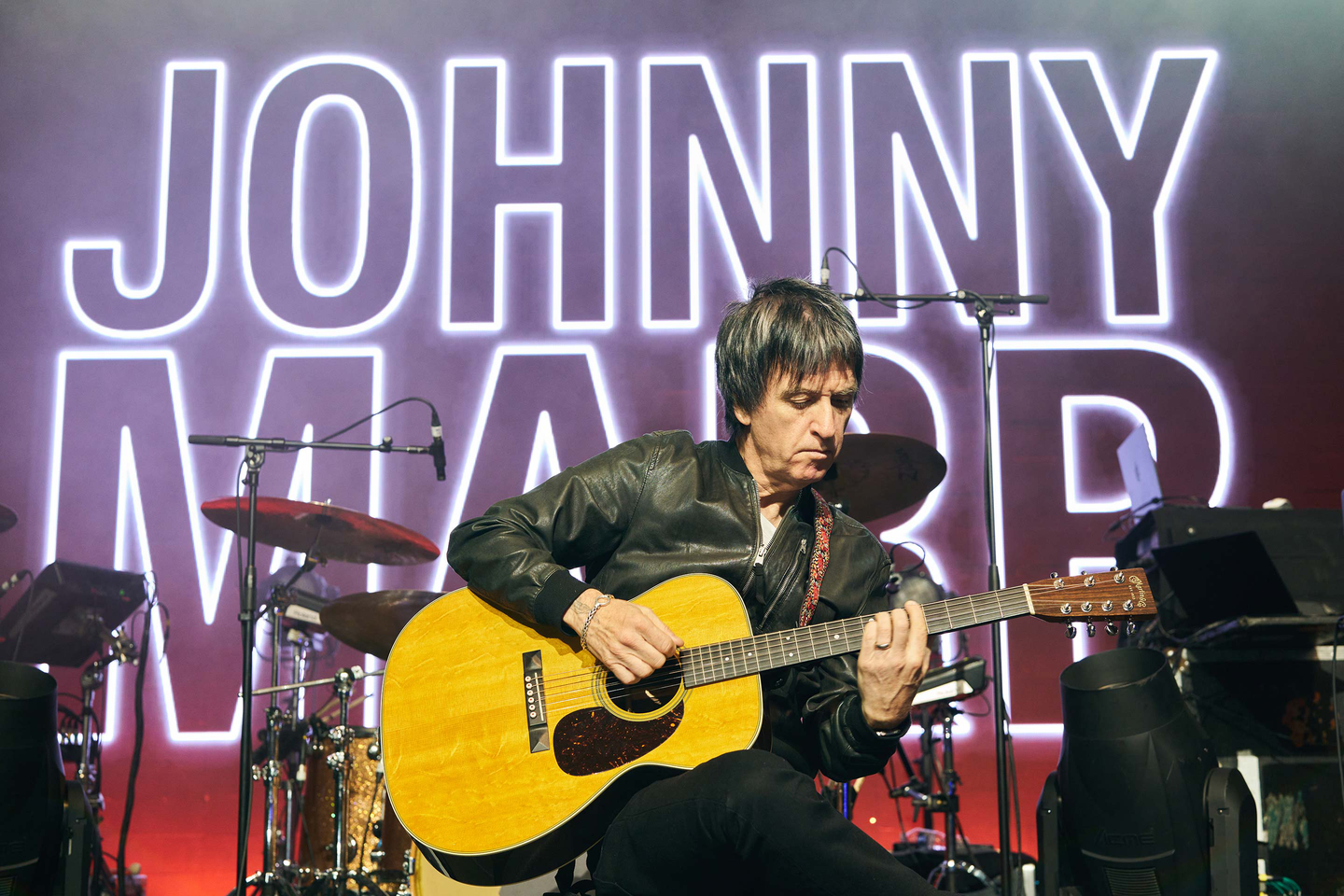Johnny Marr playing his guitar on stage