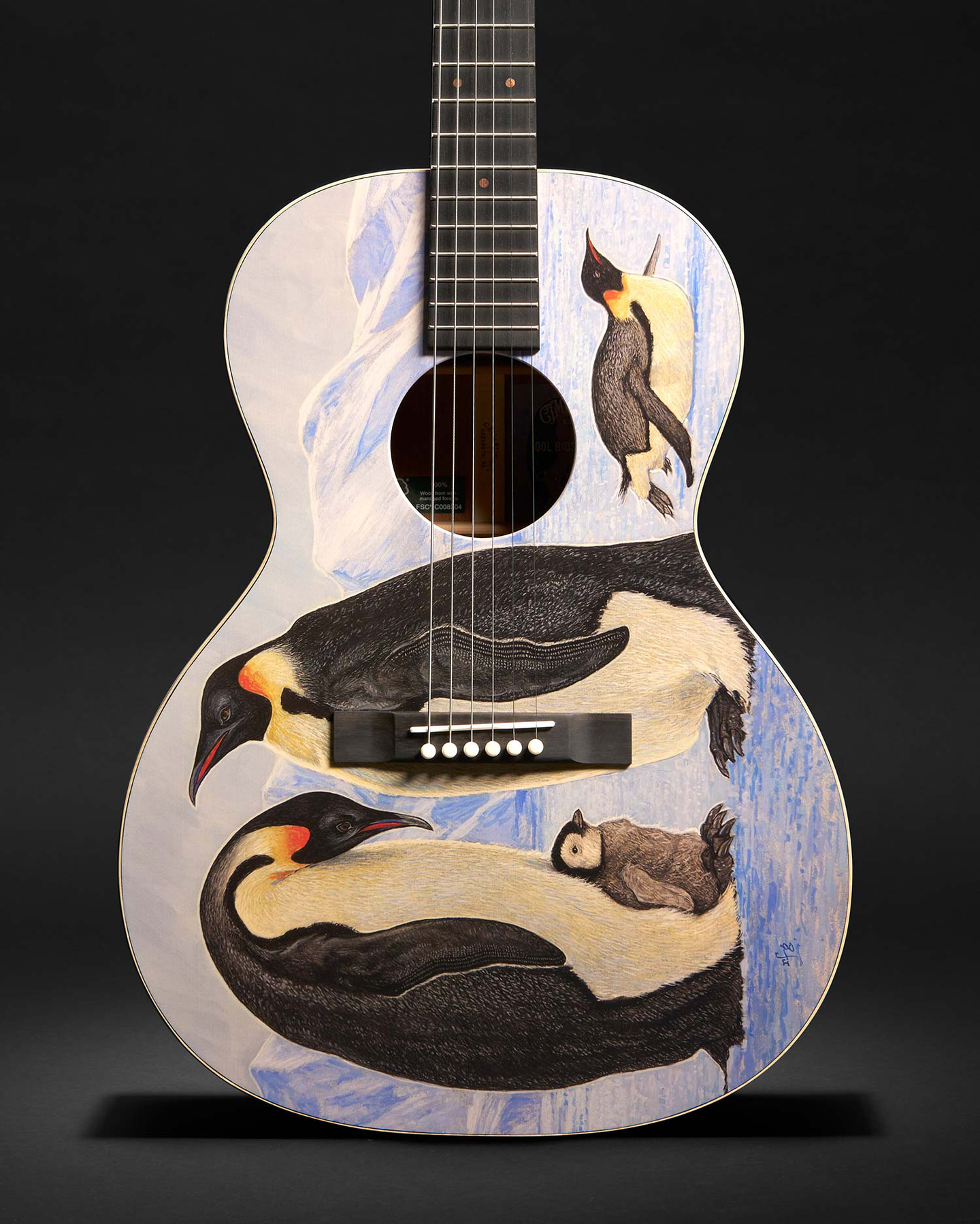 A guitar with penguins on it