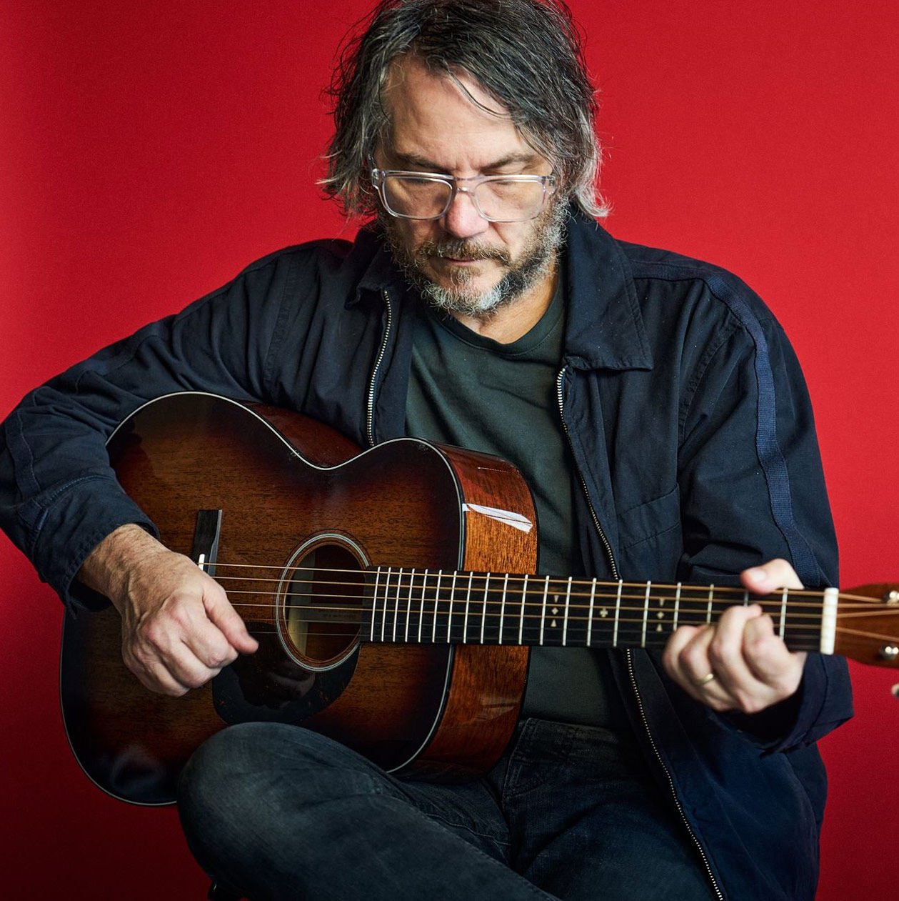Jeff Tweedy playing his signature acoustic guitar Jeff Tweedy playing his signature acoustic guitar