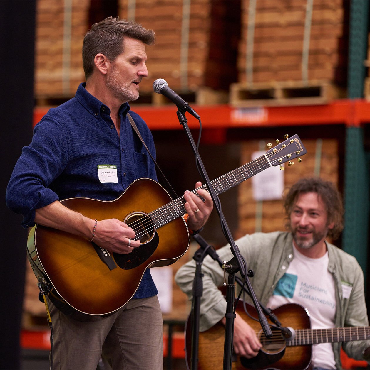 Person playing the acoustic guitar at the Sustainability Summit