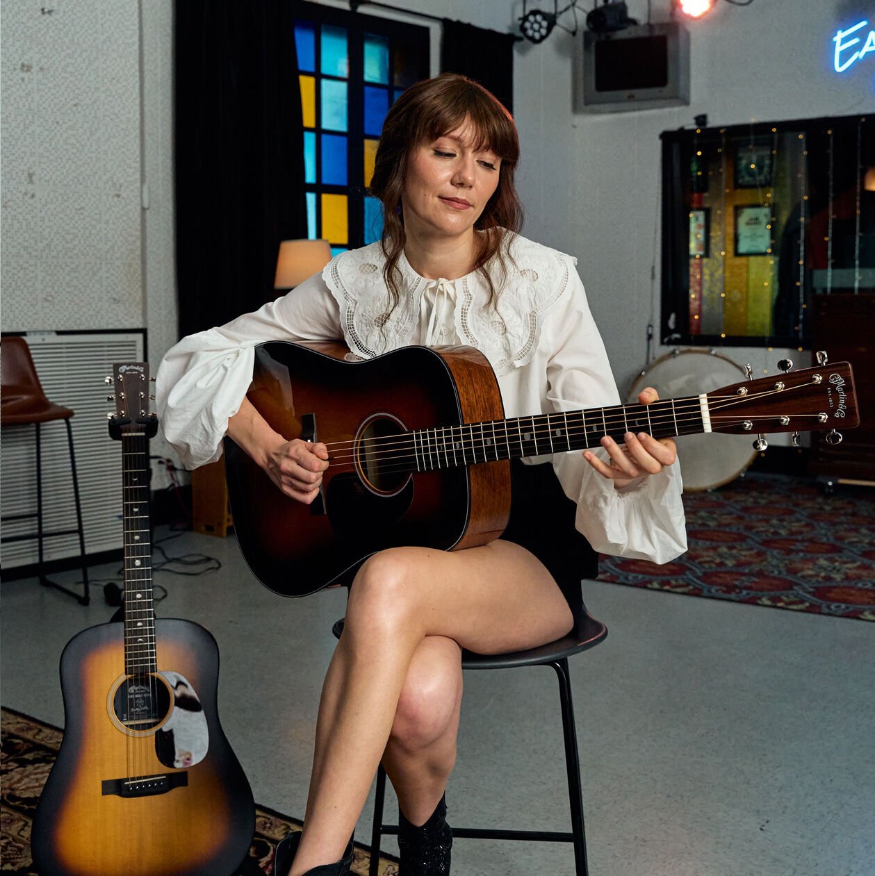 Molly playing her signature model guitar