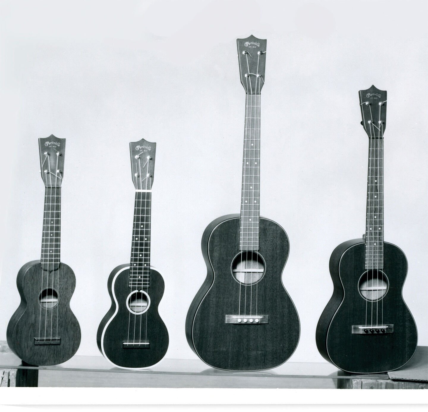 Black and white photo of Martin ukuleles