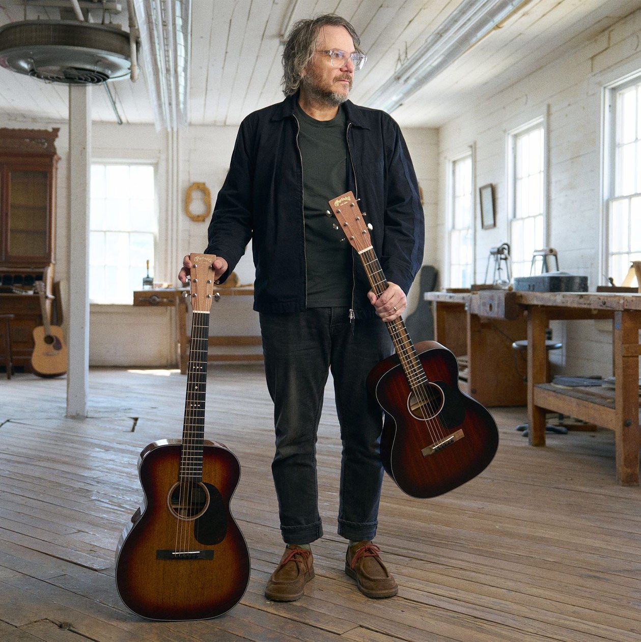 Jeff standing with his guitars in a white room Jeff standing with his guitars in a white room