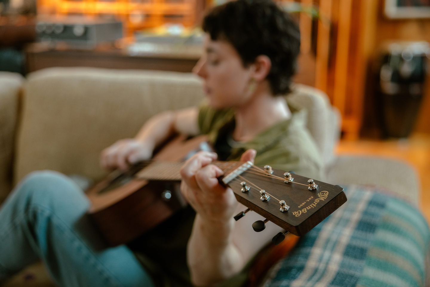 Person playing an acoustic guitar