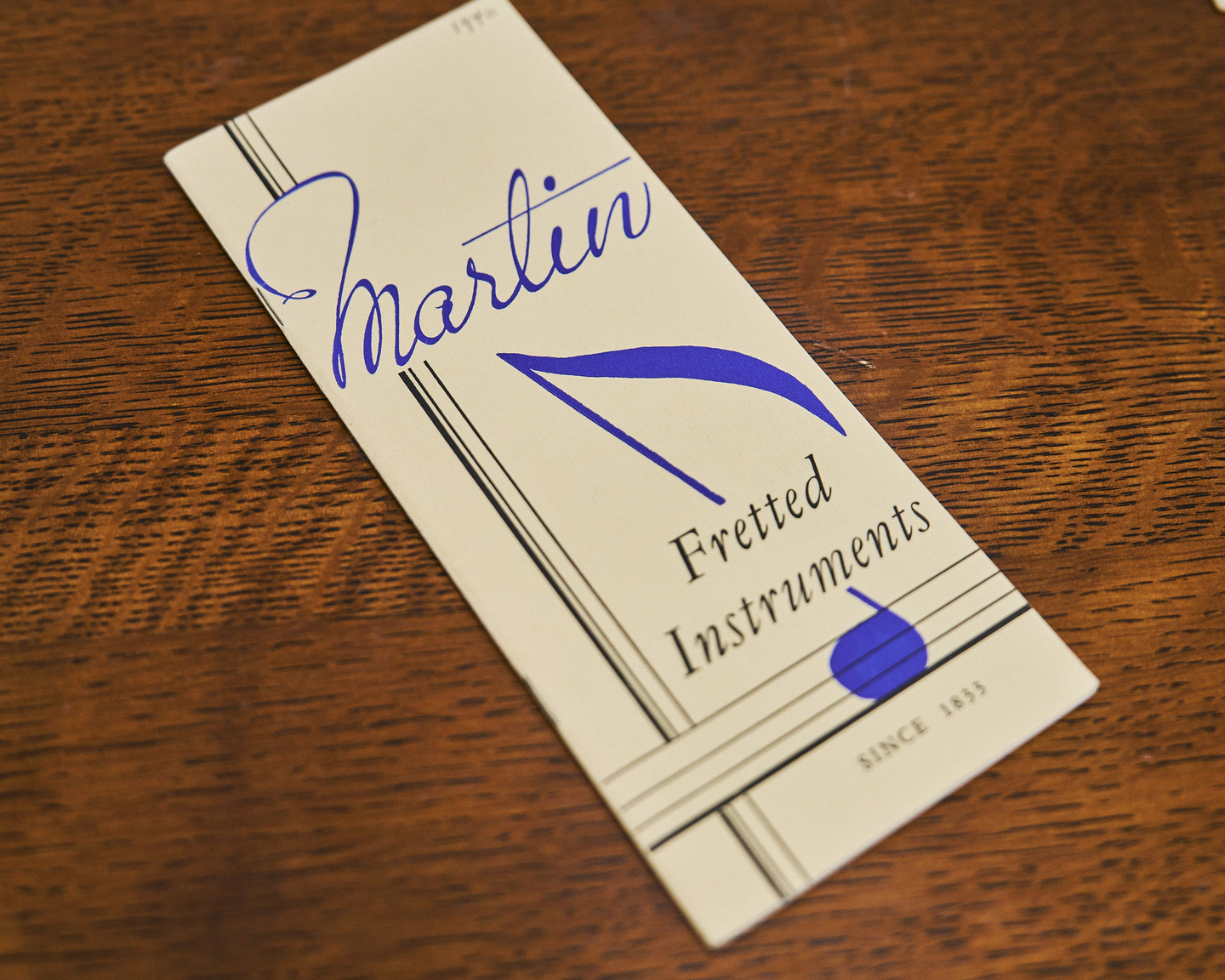 Front of the old Martin catalog, brochure shaped reading Martin Fretted Instruments