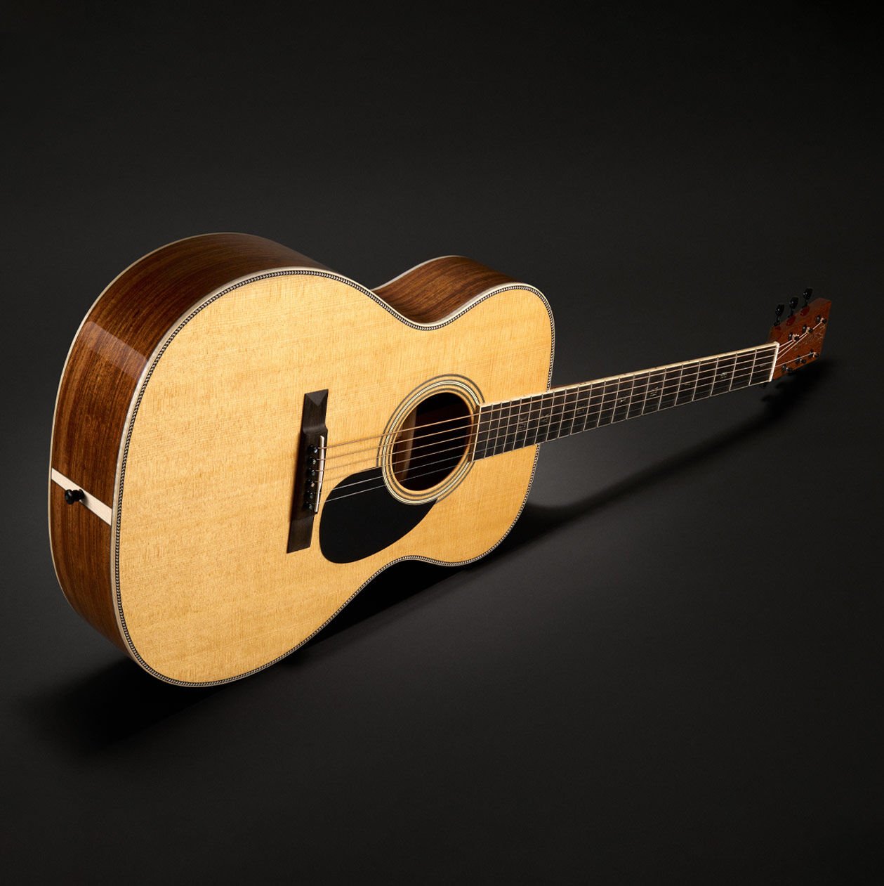 The OM Mikael Akerfeldt acoustic guitar on a black background