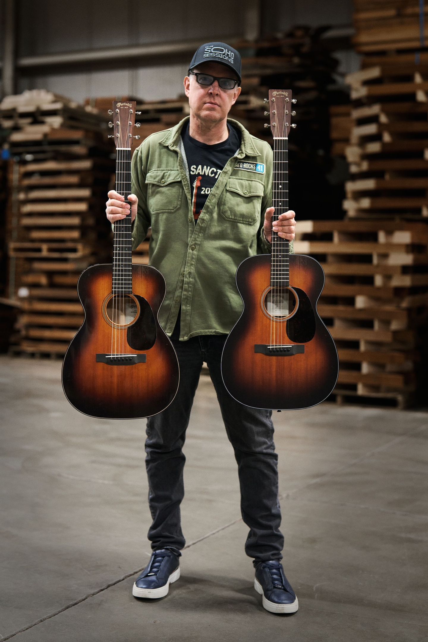 Joe Bonamassa holding his two signature model guitars