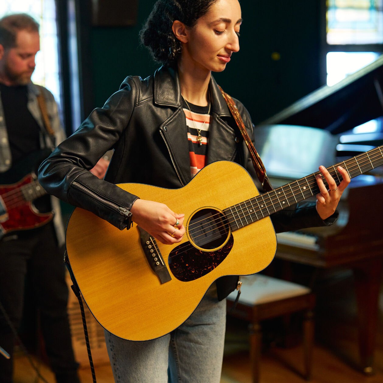 Woman playing a Road Series acoustic guitar