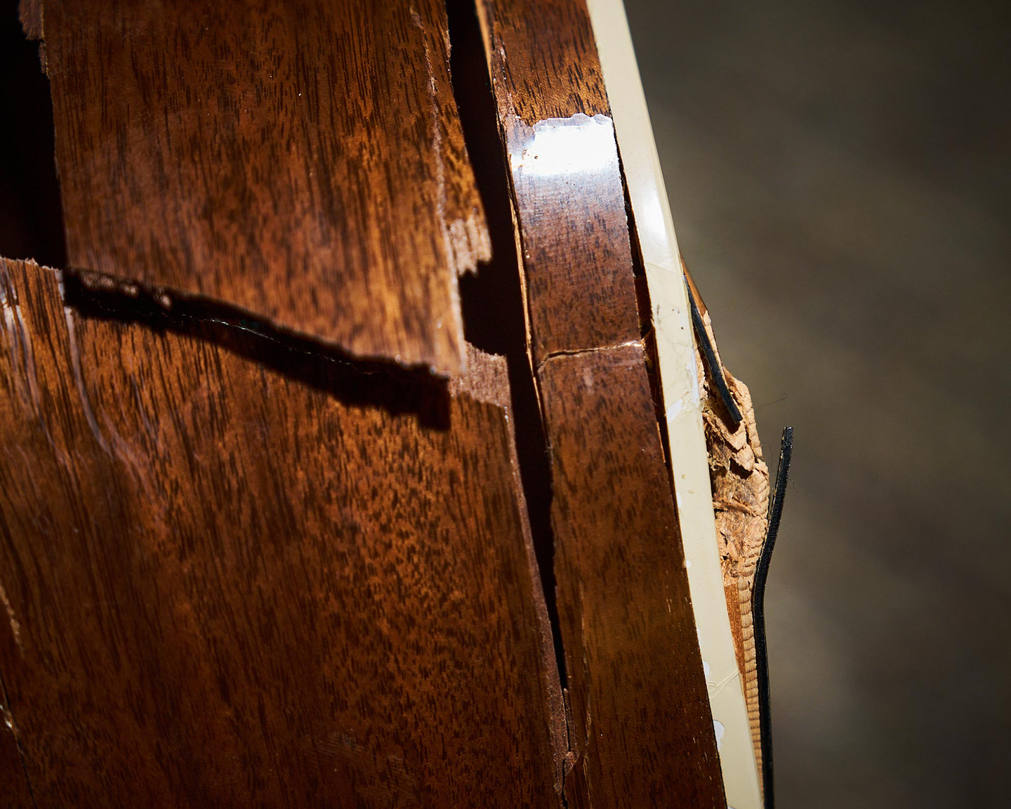A large crack in the sidewall of an acoustic guitar A large crack in the sidewall of an acoustic guitar