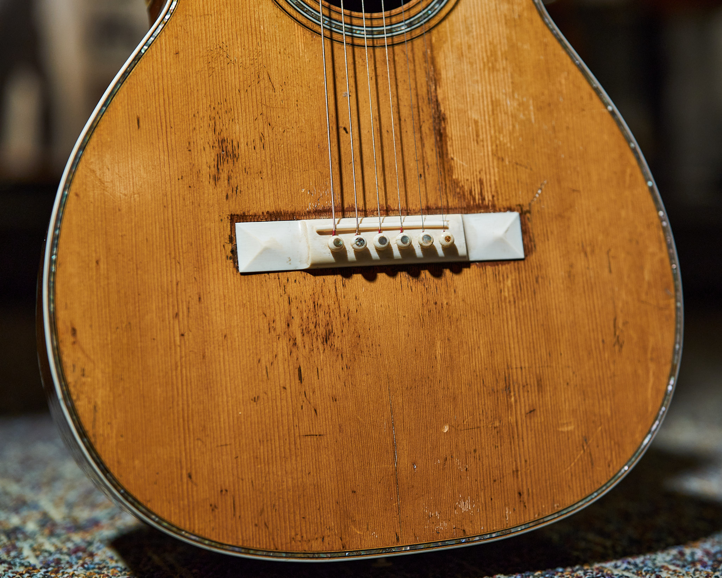 Photo of the bridge on an acoustic guitar