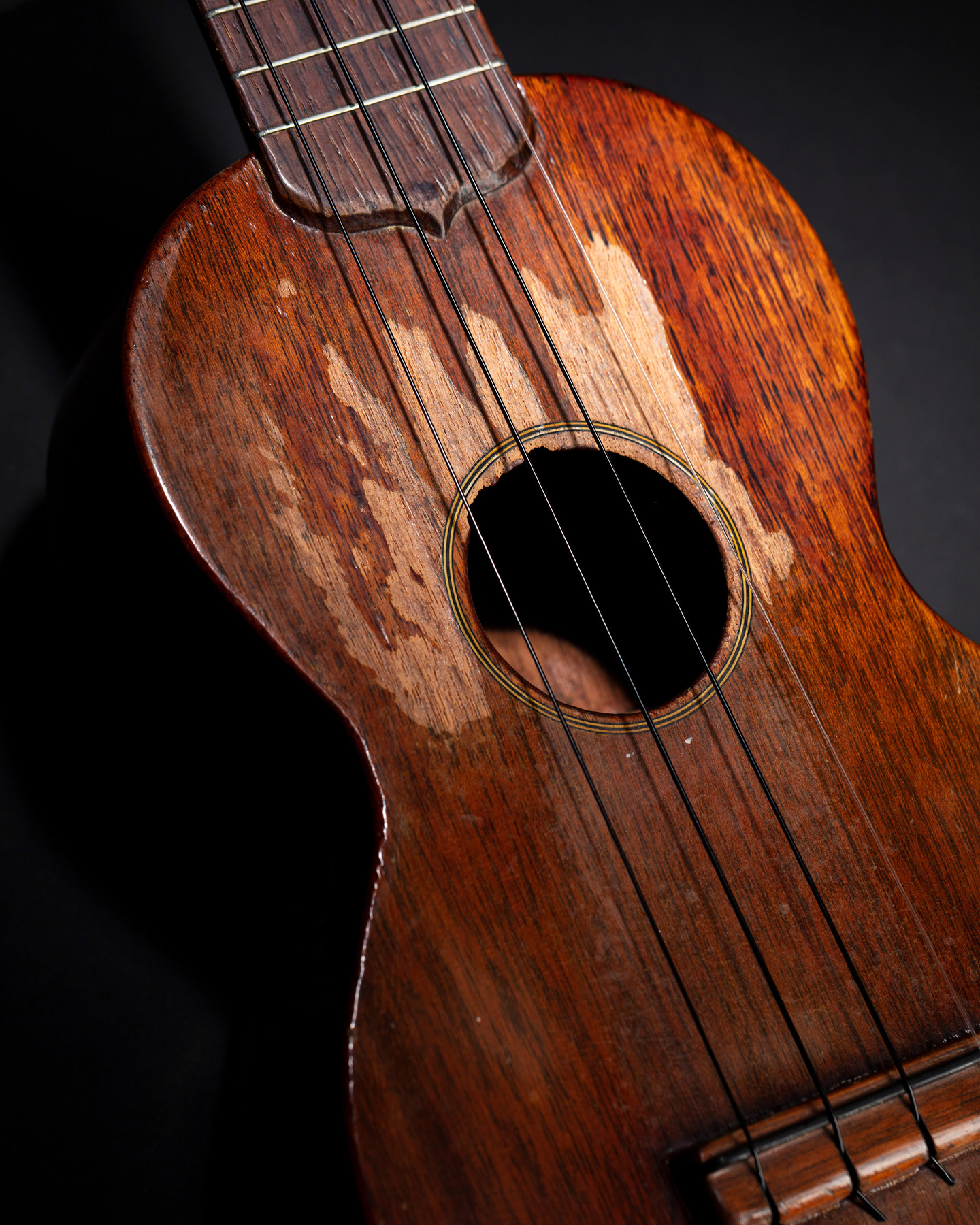 An angled shot of Tiny Tim's worn ukulele