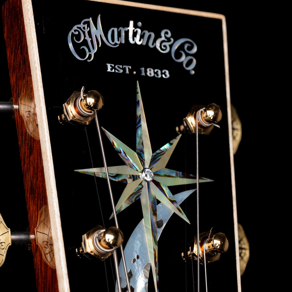 Closeup of a Martin Guitar headstock adorned with inlay work