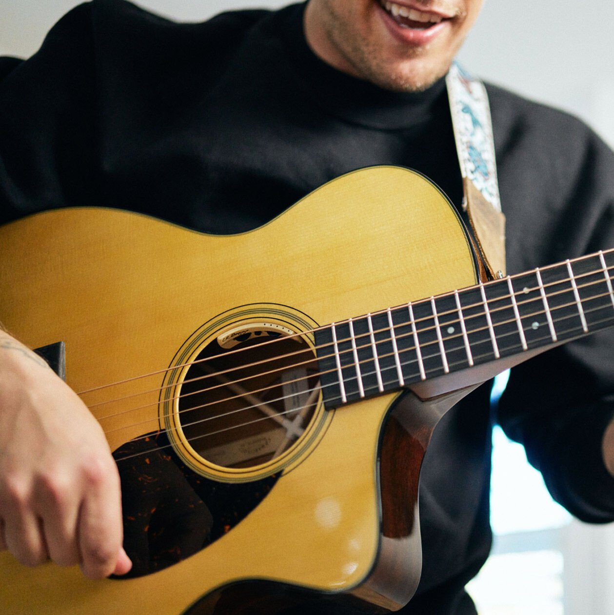 Person playing a Martin SC guitar
