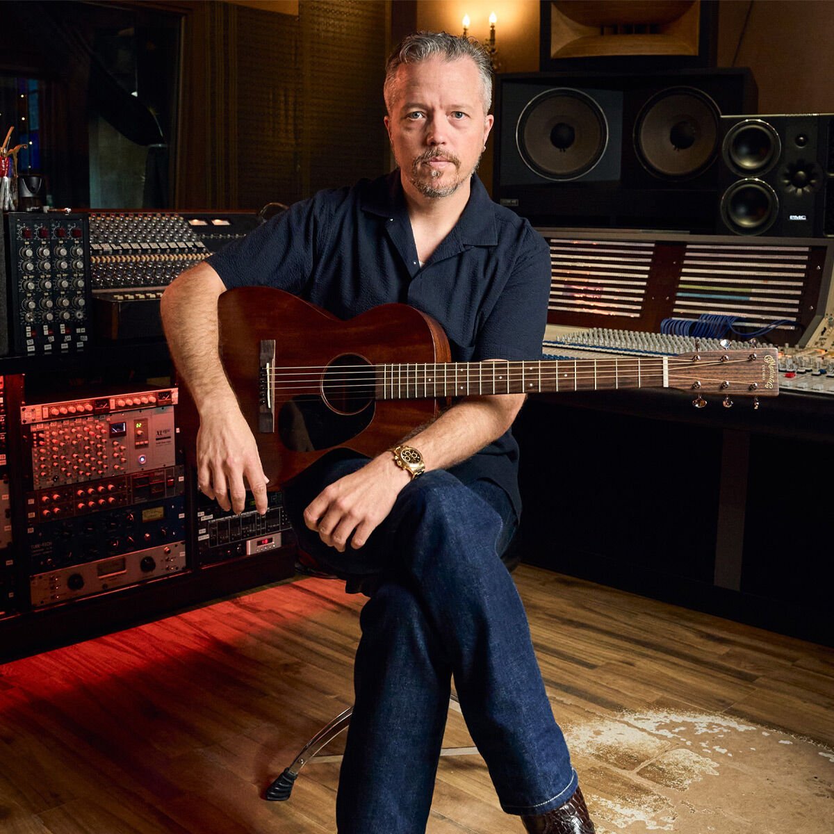 Jason Isbell sitting with his guitar Jason Isbell sitting with his guitar