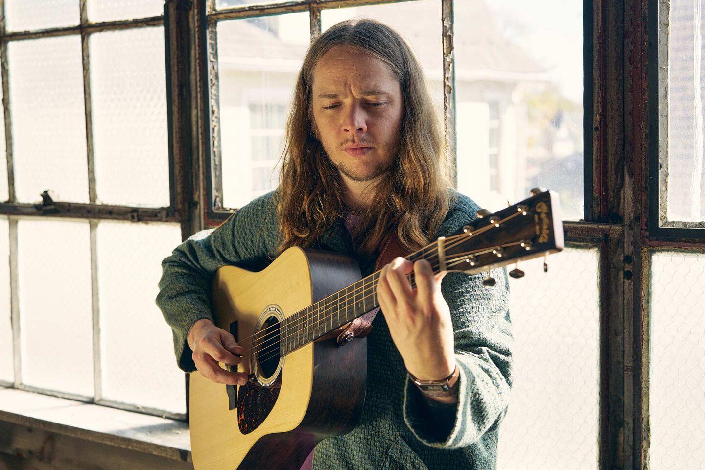 Billy Strings playing his signature D-X2E acoustic guitar