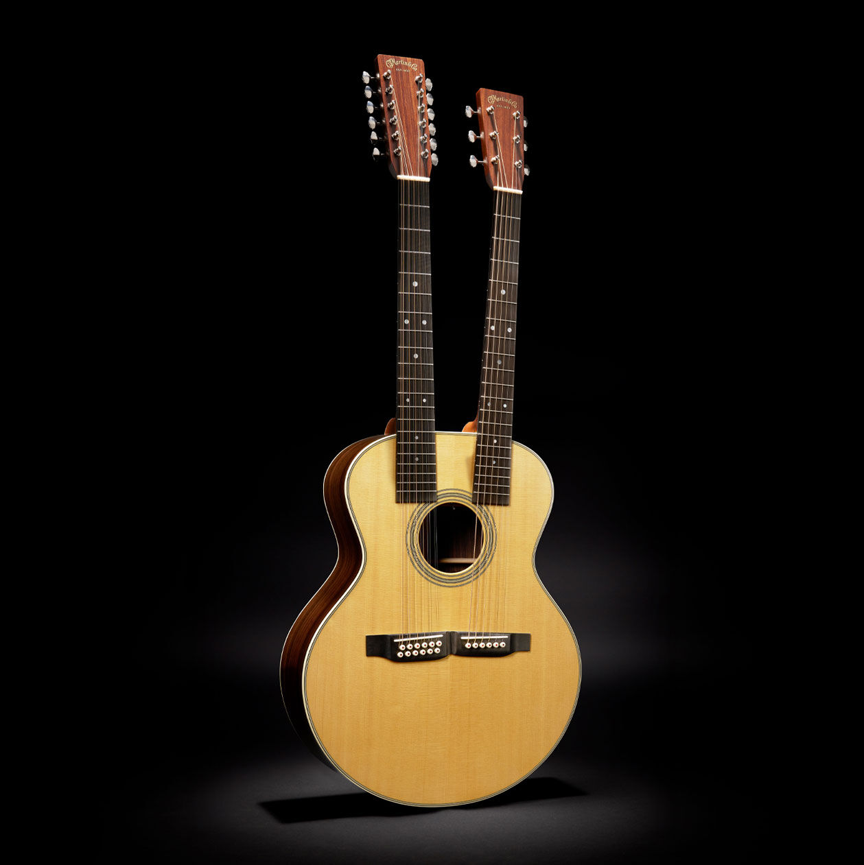 A Martin double-necked guitar on a black background.