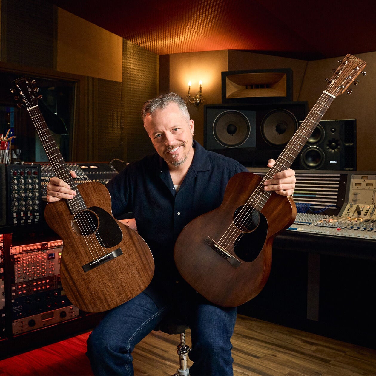 Jason Isbell holding his two signature models