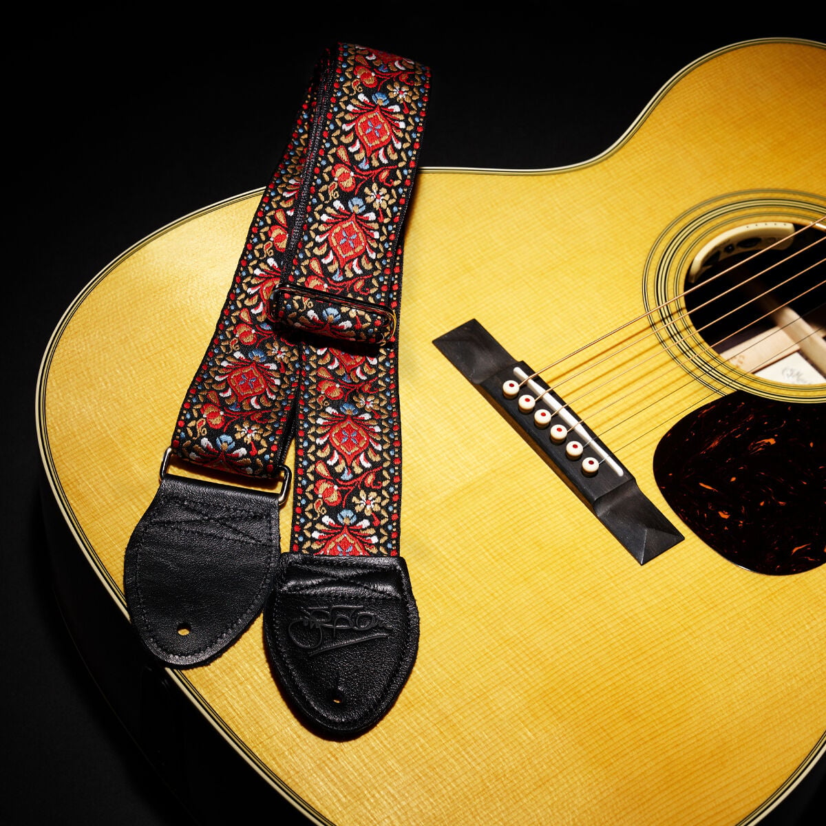 Strap resting on front of acoustic guitar