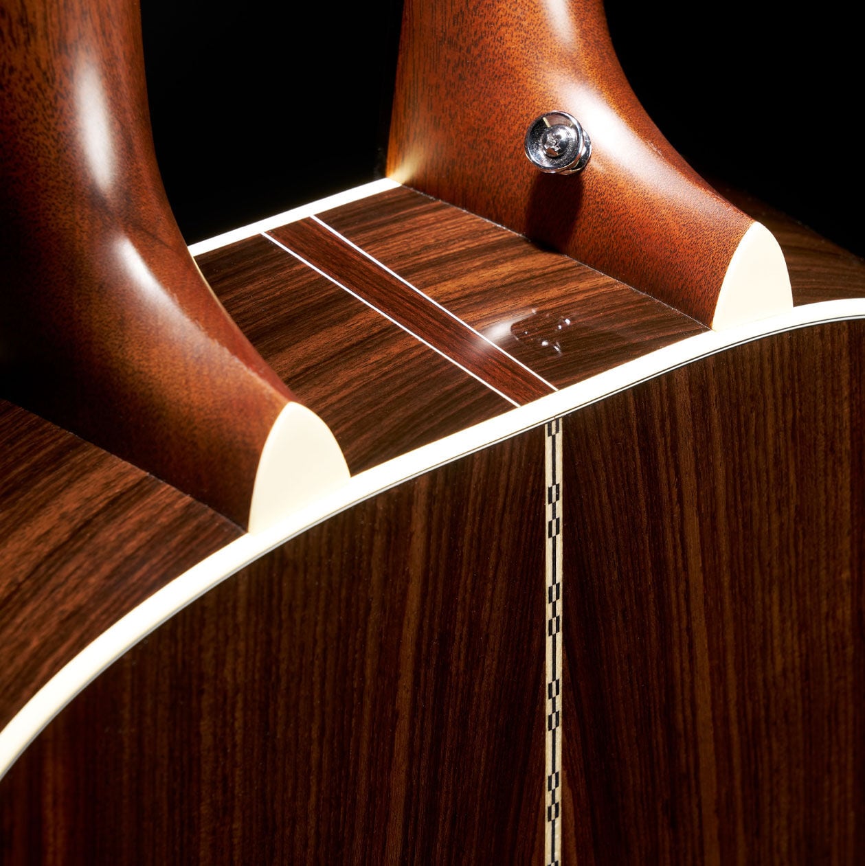 Detail shot of the two necks joining the single body of the Grand J-28E DN acoustic guitar.