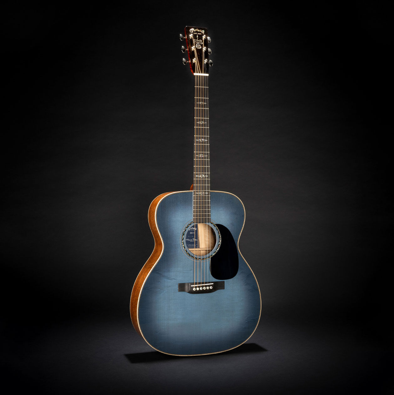 The Martin CEO-11 acoustic guitar on a black background
